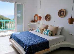 a bedroom with a bed with a view of the ocean at Beachfront Private Suites at Kalais - Stunning Sea & Sunset Views, Bus Stop Outside, Easy Naxos Town Access, Free Beach Chairs in Plaka