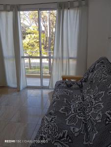 a bedroom with a bed and a large window at El descanso in San Pedro +9 photos