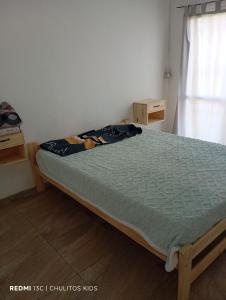 a bedroom with a bed in a room with a window at El descanso in San Pedro