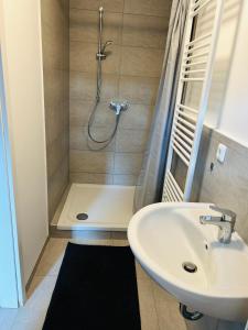 a bathroom with a shower and a sink at Blaue 8 in Rampe +18 photos