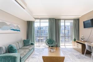 a living room with a couch and a large window at Harbour Bridge 401 by CTHA in Cape Town