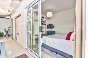 a bedroom with a bed and a large window at Cape Town Gem in Cape Town