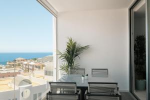 a table and chairs on a balcony with a view of the ocean at Isla Bonita Blik by Huskalia in Puerto Naos