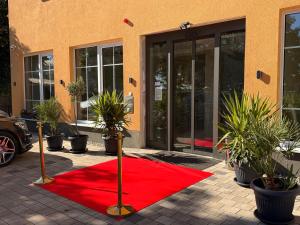a red carpet on the ground in front of a building at Art Hotel in Augsburg