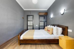 a bedroom with a bed with white sheets and pillows at Apartment KeyGo #0191 comfort and coziness in the city in Yerevan