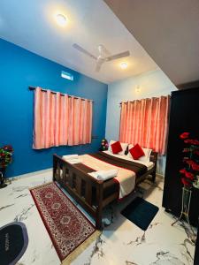 a bedroom with a bed with blue walls and red curtains at Coorgsierra in Madikeri
