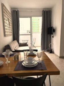 a living room with a table and a couch at LK Centro 1 in Belo Horizonte