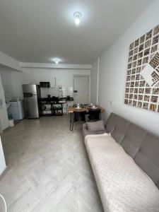 a living room with a couch and a kitchen at LK Centro 1 in Belo Horizonte