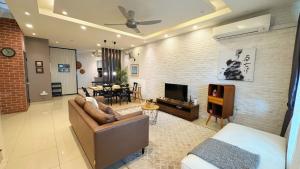 a living room with a couch and a dining room at Bangi Avenue, 43000 Kajang Fully Air-Con Homestay in Kajang +24 photos