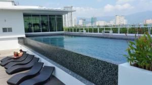 a large swimming pool on the side of a building at Urbano Luxury Homestay at Maritime in George Town
