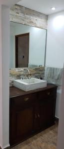 a bathroom with a sink and a large mirror at Casa vacaciones Camet Norte in Camet Norte +30 photos