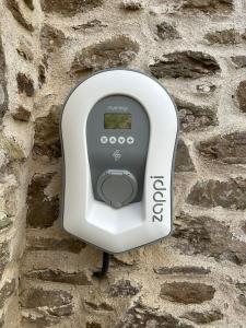 a soap dispenser on a stone wall at Luxury Farmhouse Retreat with Private Hot Tub & EV in Kentisbury +47 photos
