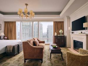 a hotel room with a bed and a fireplace at The Langham, Shenzhen in Shenzhen