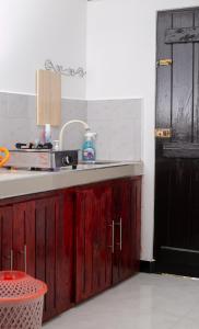 a kitchen with a counter and a sink and a door at The Hollyoak - Vintage Charm with Modern Comforts in Denipitiya +9 photos