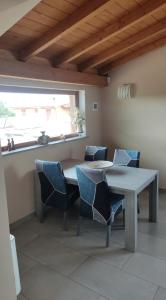 a dining room with a table and chairs and a window at La tana della Fenice in Labico