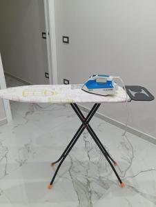 a surfboard on a stand on a marble floor at Il bacio del sole in Casola di Napoli