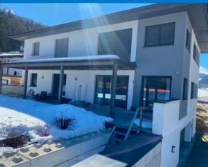 a house with snow on the ground in front of it at Apart Promonti in Nauders