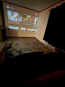 a dark room with a projection screen on a wall at Secret Factory & Spa in Soultz-Haut-Rhin