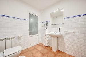 a white bathroom with a sink and a toilet at Tejería 20 by Clabao in Pamplona +34 photos