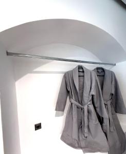 a coat hanging on a rack in a room at Cycladic Suite in Thessaloniki