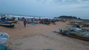 a group of boats on a sandy beach at The Corner House by Liz Non Airconditioned in Mahabalipuram