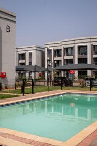 a large swimming pool in front of a building at The Dawn in Gaborone