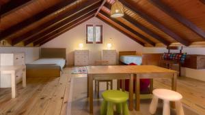 a room with a table and chairs and a bedroom at Casa das Marias in Ponta do Pargo