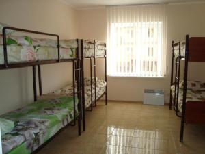 a room with four bunk beds and a window at Hostel Sofia in Zhytomyr