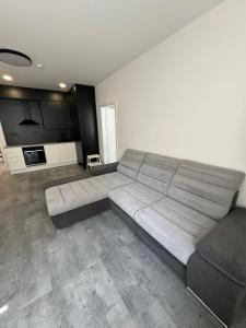 a large couch in a room with a kitchen at Central APT Opava in Opava
