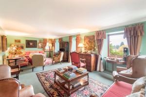 a living room filled with lots of furniture at Glenogle Highland Estate Home in Lochearnhead