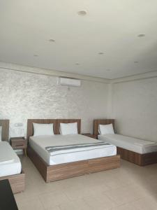 two beds in a room with two beds sidx sidx sidx at SAFI VACANCES in Safi +107 photos