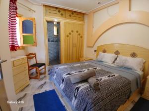 a bedroom with a bed and a desk and a chair at Blue House Town in Chefchaouen