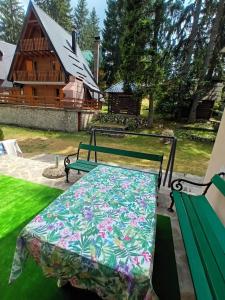 a bed in a yard with a house in the background at Vikendica Luna in Gornja Šišava +4 photos