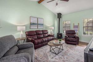 a living room with couches and a couch and tables at 4BR Game-Day Retreat - Foosball & Fire Pit in Fayetteville