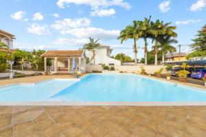 a swimming pool in the backyard of a house at Serenity Bay - Perfect Tropical Stay in Pointe aux Cannoniers