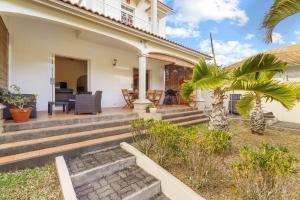 a home with a porch and stairs to a house at Serenity Bay - Perfect Tropical Stay in Pointe aux Cannoniers +18 photos
