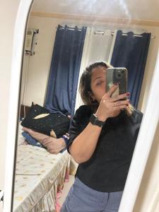 a woman taking a picture of herself in a mirror at Espineli Transient Home in Surigao