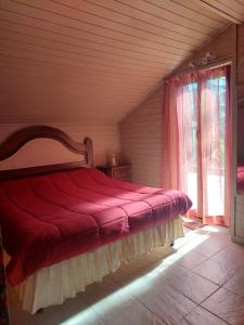a bedroom with a bed with a red blanket at Alloggio Panorama in Rocca di Papa