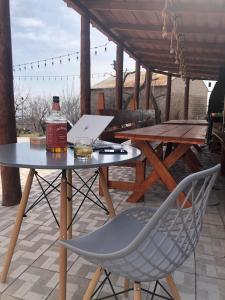 a table with a bottle of whiskey and a chair on a patio at Toneh Villa in Lernarot