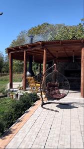 a bench sitting on a patio with a gazebo at Toneh Villa in Lernarot
