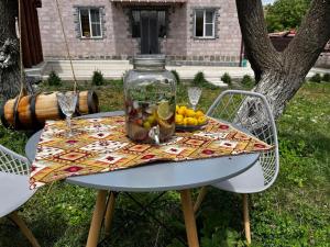 a table with a jar of fruit on top of it at Toneh Villa in Lernarot