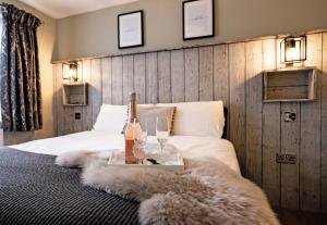 a bedroom with a bed with a bottle of champagne and glasses at Chestnut Meadow Country Park in Sidley