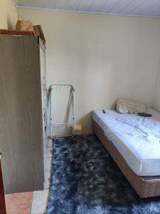 a small bedroom with a bed and a closet at Ferreira hostel in Florianópolis