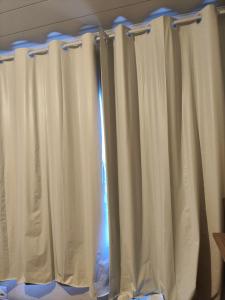 a curtain in a room with white curtains at Ferreira hostel in Florianópolis