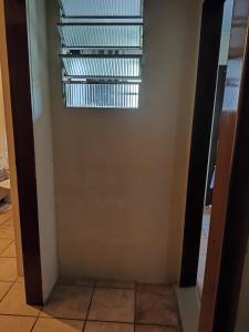 a hallway with a window in a room at Ferreira hostel in Florianópolis