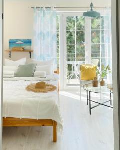 Un dormitorio con una cama y una mesa y ventanas. en Mari Vera, en Mielno 33 fotos más