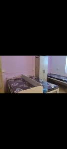 a picture of a kitchen with two pans on a counter at Vyavasthapan hostels in Pune