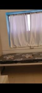 a bed in a train with a window at Vyavasthapan hostels in Pune +1 photo