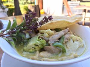 a bowl of soup with meat and vegetables and greens at The Orchard Addo in Addo