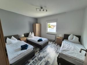 Ένα ή περισσότερα κρεβάτια σε δωμάτιο στο Ferienhaus Thalia 2 a